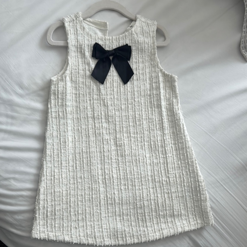 Elegant White Sleeveless Dress with Black Bow